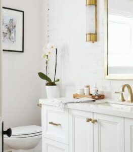 Re-Bath bathroom remodel with white and gold color palette